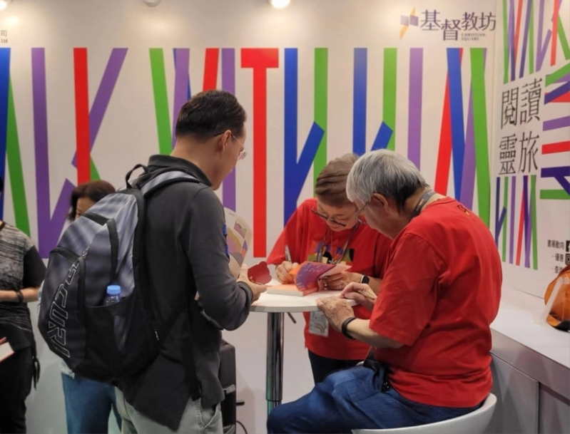 Rev. Peter Ho and his wife, Mrs. Shirley Loo, both popular authors, attract a queue of fans waiting for book signings and photos.