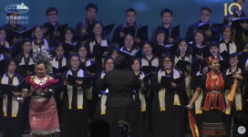 The opening ceremony features a choir singing in Malay and English, accompanied by dancers performing traditional Malaysian ethnic dances.